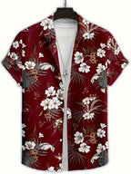 A short-sleeve button-up camp shirt with a red base and a white, gray, and brown tropical floral print, displayed on a hanger over a white t-shirt.