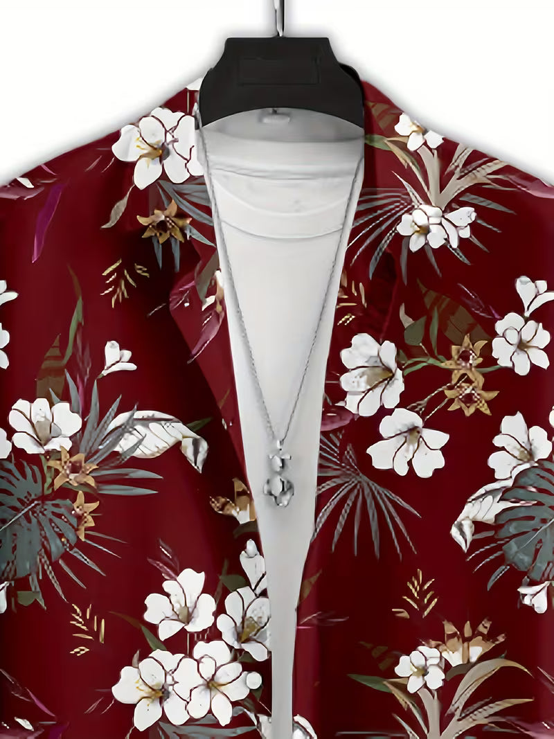 A red tropical floral print blazer with white flowers and green palm leaves, styled open over a white t-shirt on a black hanger with a silver pendant necklace.