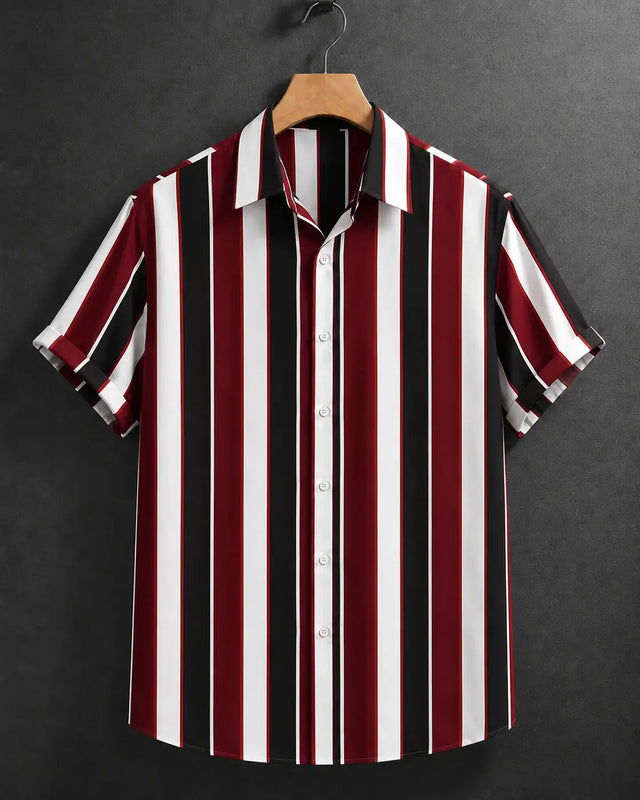 A short-sleeve button-up shirt with vertical stripes in burgundy red, black, and white, hanging on a wooden hanger against a dark gray textured background.