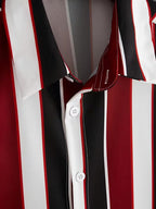 Close-up of a striped button-up shirt with vertical red, black, white, and gray stripes, featuring white buttons and contrast stitching.