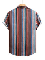 A short-sleeve button-up shirt with a vertical striped pattern in red, blue, brown, and white, hanging on a wooden hanger against a plain white background.