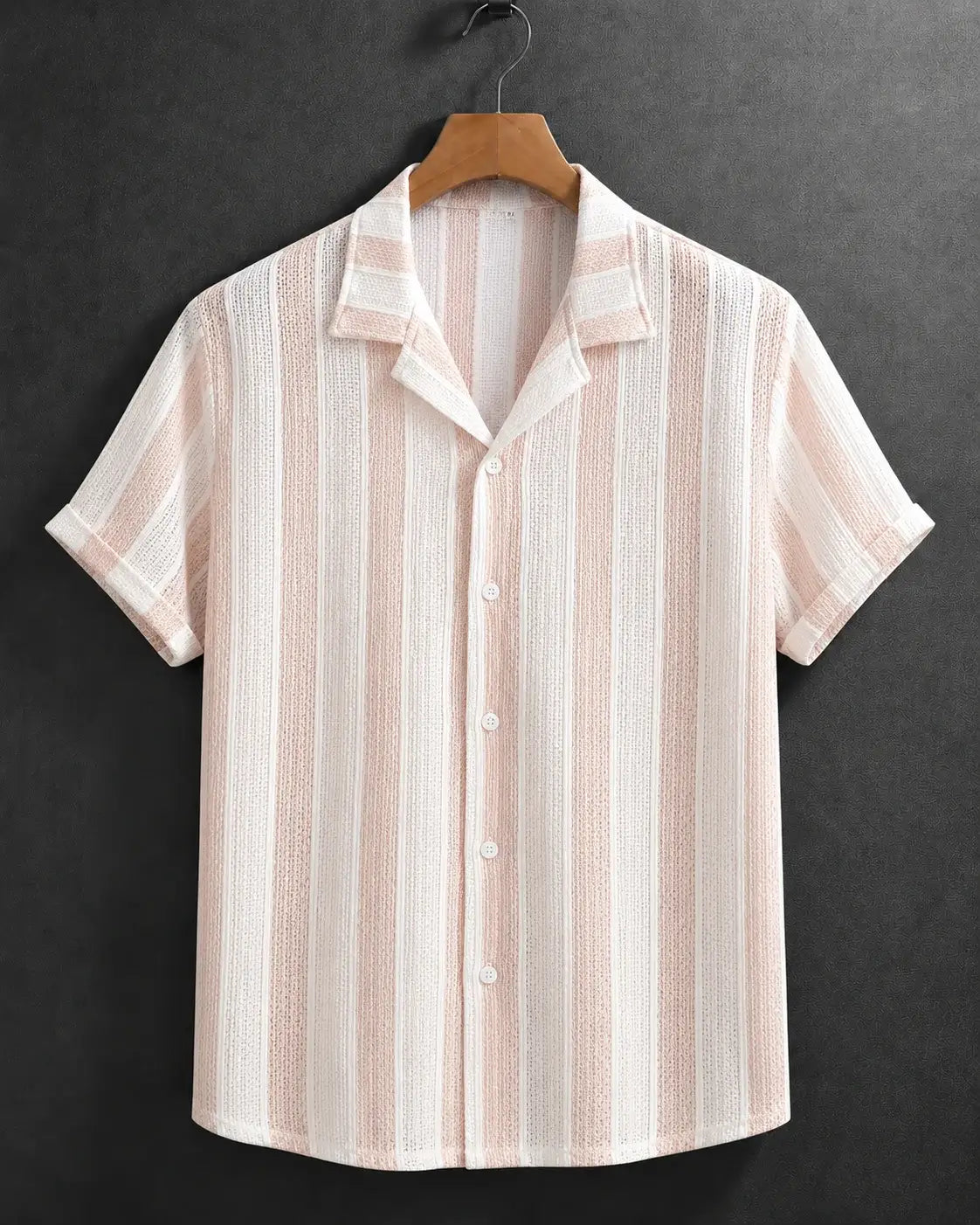 A short-sleeve button-up shirt with vertical stripes in light pink and off-white, featuring a textured woven pattern. The shirt is displayed on a wooden hanger against a dark gray textured background.