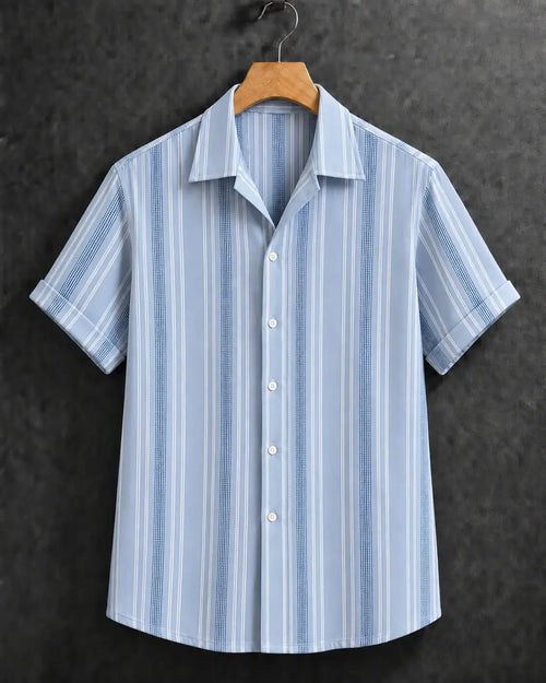 A light blue and white vertically striped short-sleeve button-up shirt hanging on a wooden hanger against a dark textured background.