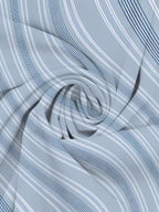 A close-up of a light blue fabric with a pattern of thin white and dark navy blue stripes, arranged in a swirling, draped texture.