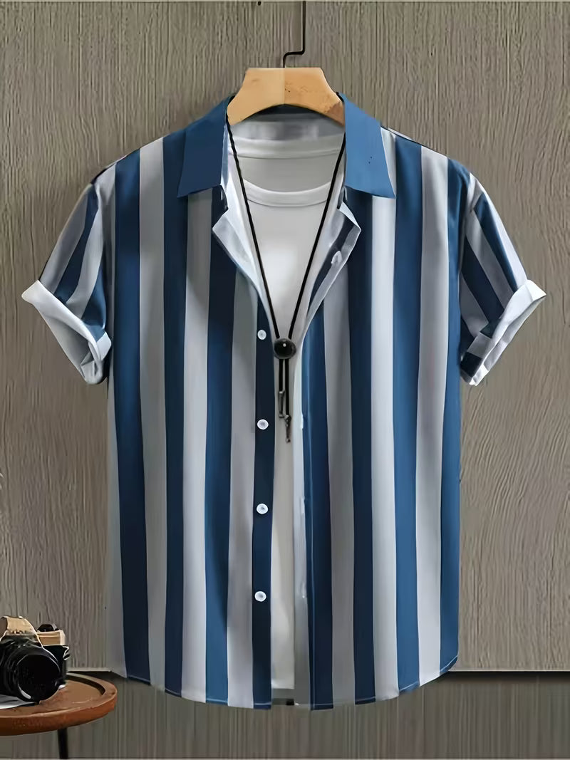 A men's short-sleeve button-up shirt with vertical blue, navy, and white stripes, styled open over a white t-shirt on a wooden hanger against a textured gray wall.