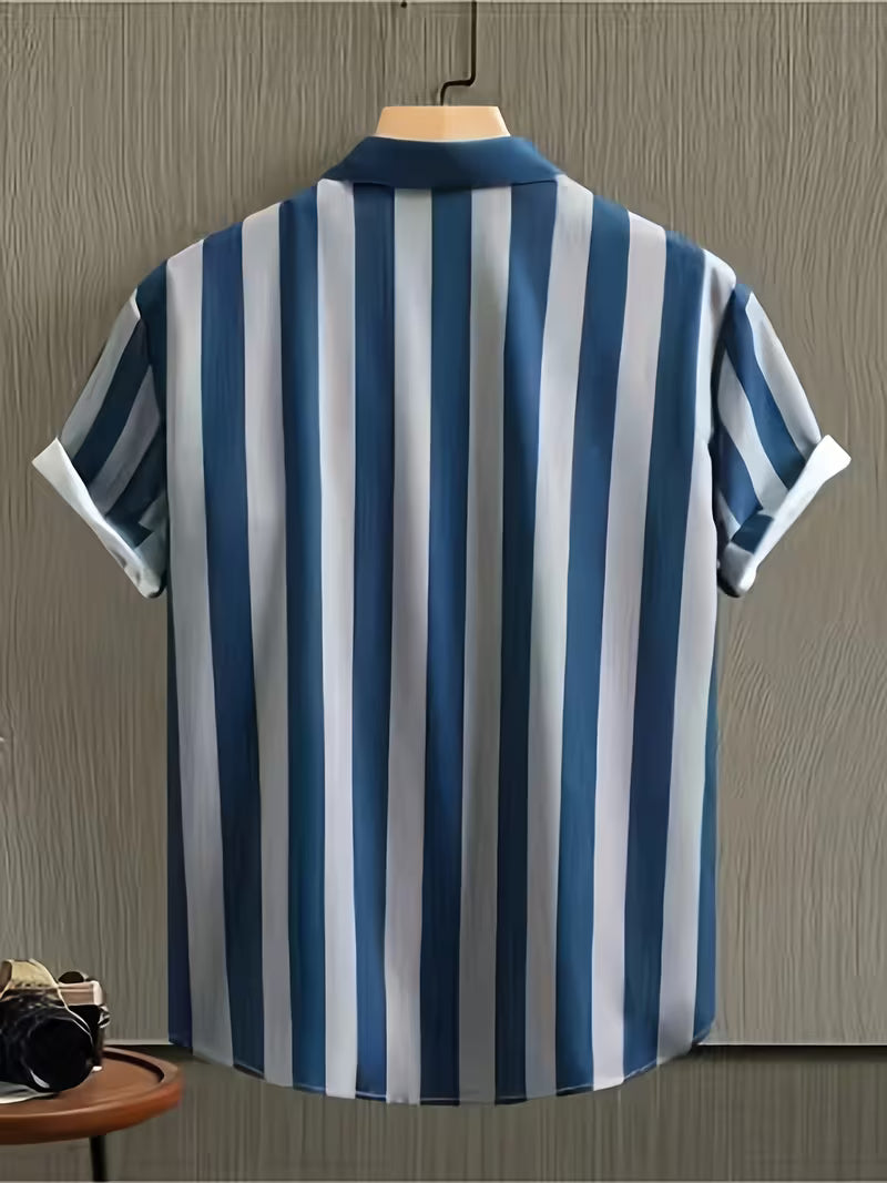 A short-sleeve button-up shirt with vertical blue and white stripes, hanging on a wooden hanger against a gray wood-paneled wall.