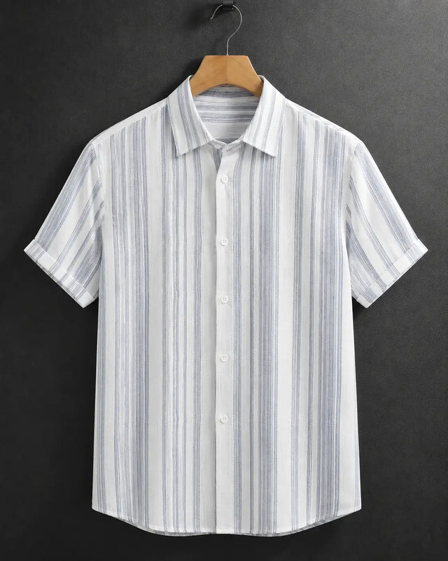 A short-sleeve button-up shirt with vertical blue and white stripes, hanging on a wooden hanger against a dark gray background.