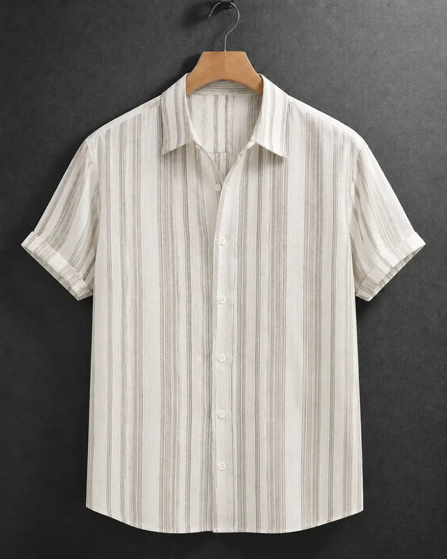 A short-sleeve button-up shirt with vertical beige and brown stripes on an off-white base, hanging on a wooden hanger against a dark textured background.