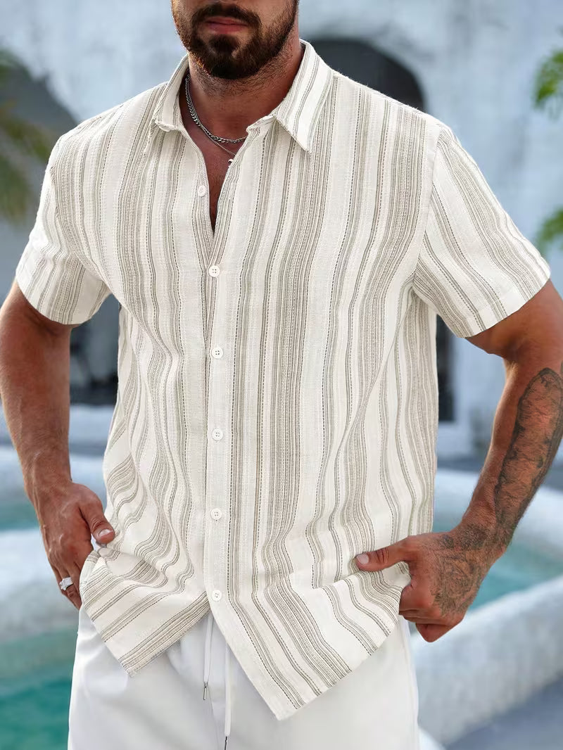 Man wearing a beige and white striped shirt with a blurred poolside background