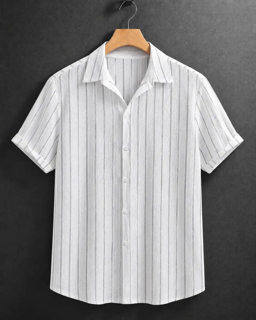 A white short-sleeve button-up shirt with thin vertical gray stripes, hanging on a wooden hanger against a dark gray textured background.