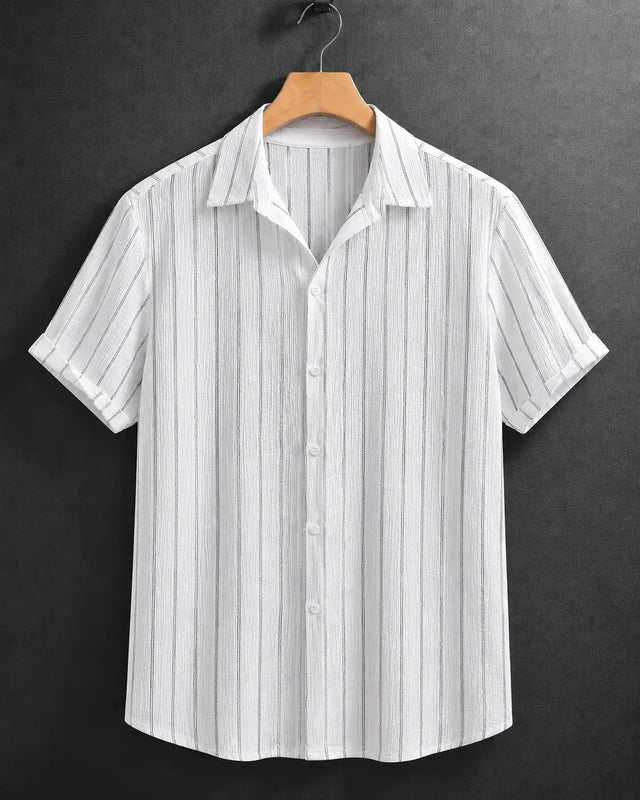 A white short-sleeve button-up shirt with thin vertical gray stripes, hanging on a wooden hanger against a dark gray textured background.